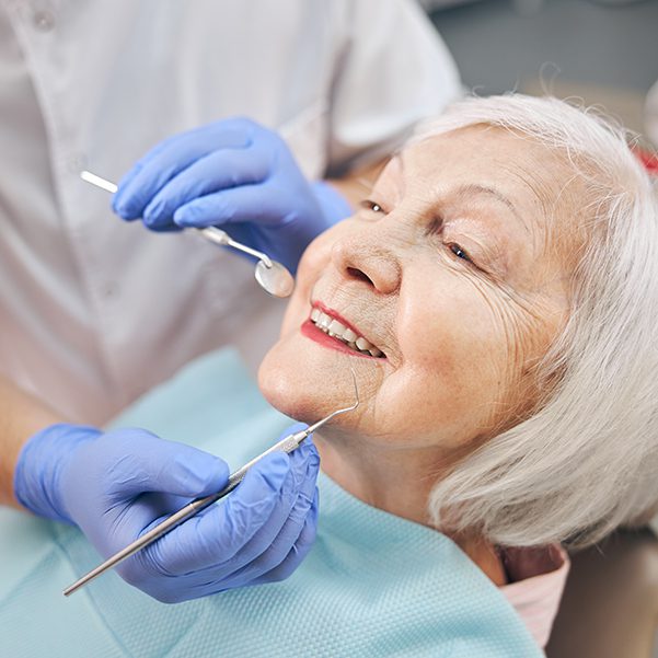 Close up portrait of elderly woman check up and having the consultation with dentist at the dental office