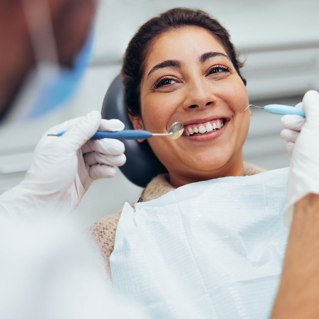 Female having routine dental checkup at dentist.